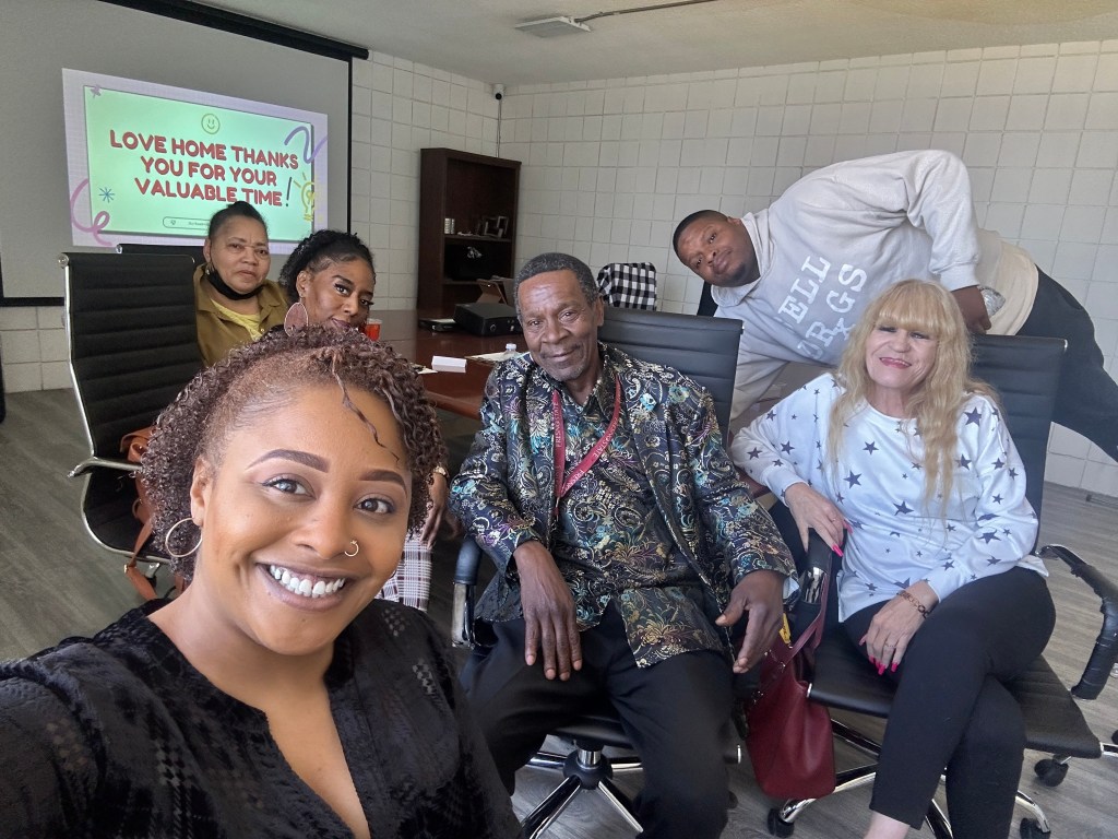 An image of staff members including the Director of Marketing, Brandi Zike, smiling at the camera for a quick selfie after a very productive meeting.